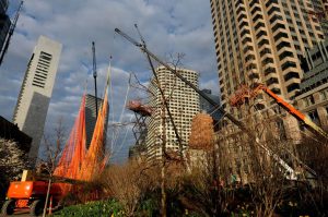 Multiple cranes and lifts work to hoist the net above the tree line on the Greenway. (Photo credit: Harry Brett)