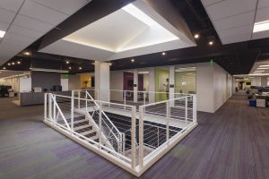 Dramatic skylights on the 7th floor draw natural light into the space, while connecting stairs unify the multiple floors.   