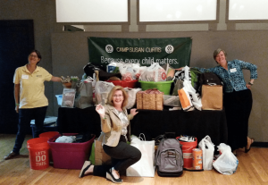 Camp Susan Curtis staff Melissa Cilley, Executive Director; Lori Southworth, Director of Grants and Special Events; and Jessica Eller, Office Associate accepting gifts from Lavallee Brensinger Architects' Laugh the kids UPTA CAMP event.