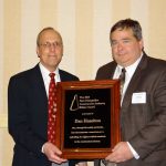 Dan Hazelton (right), New England general manager for Anderson Equipment, accepts the NH Construction Industry Ethics Award from the award's sponsor, David W. Wood.
