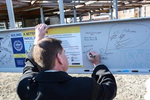 Mayor Walsh signing the beam.