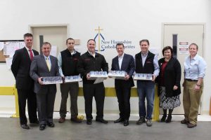 (L-R) Tom Blonski, NH Catholic Charities, John Dumais, NH Grocers Association and NH Food Bank Advisory Board, Mark Makmann, CFO Metro Walls, Mike Dion, President, Metro Walls, Arthur Sullivan, NH Food Bank Advisory Board, Steve Gagnon, VP of Operations, Metro Walls, with Dominque Rust, and Mel Gosselin, NH Food Bank Executive Director