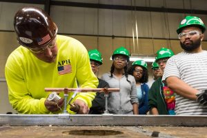 Bill Ferguson demonstrates soldering to students